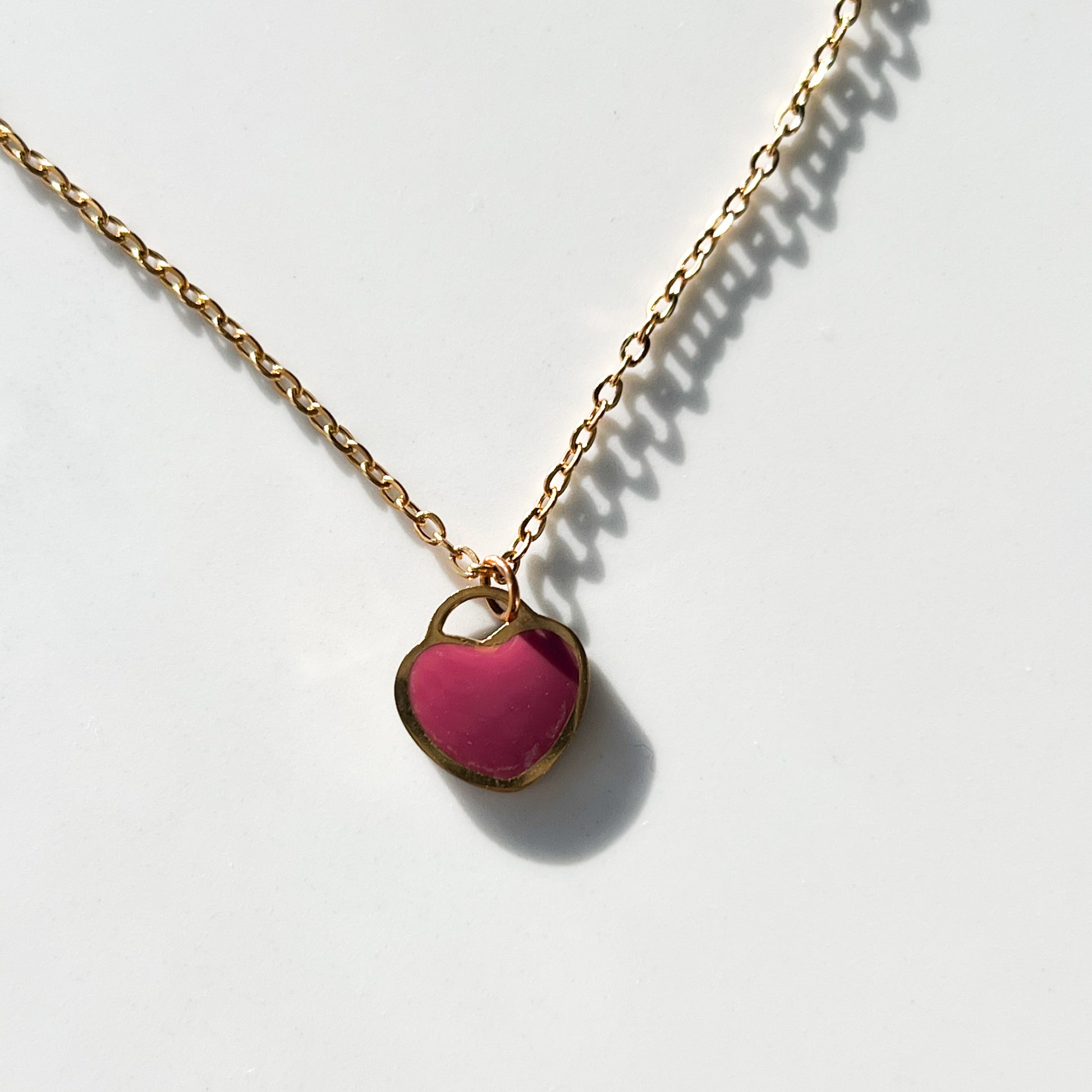 Pink heart necklace on gold chain